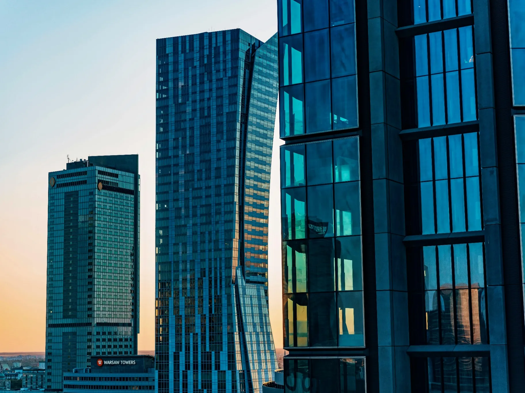 Modern glass skyscrapers in Warsaw business center at sunset