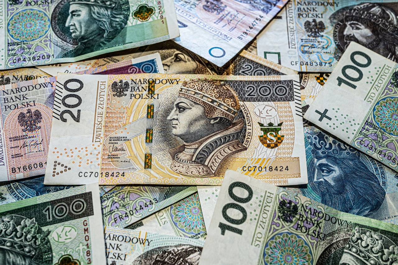 Polish złoty banknotes of various denominations spread out on a surface
